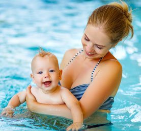 young mom with her baby at our parent and tot swim class in Stafford